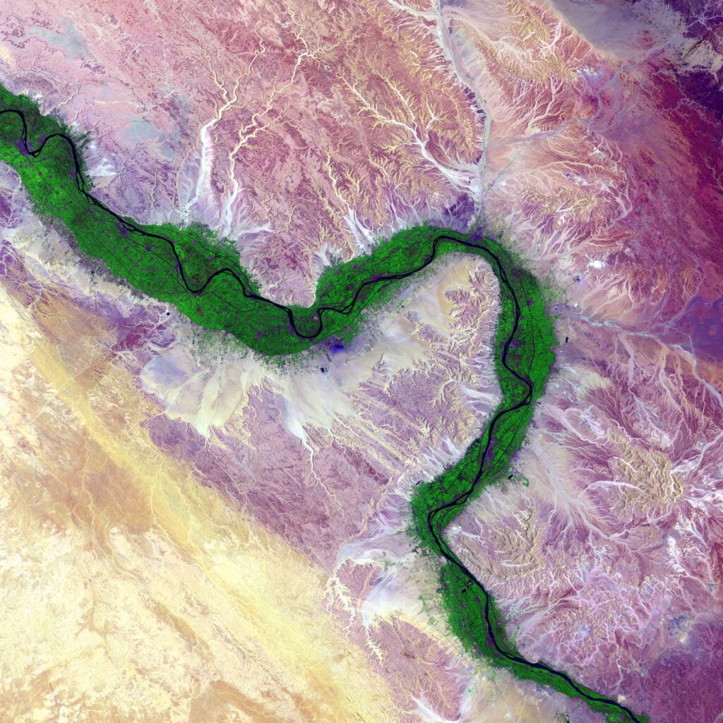 Aerial view of the Nile River. Green farmland marks a distinct boundary between the Nile floodplain and the surrounding harsh desert.
